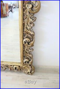 Grand miroir de style baroque ancien en bois sculpté et doré sec. XX