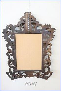 Miroir raffiné de style baroque ancien en bois sculpté et doré sec. XX